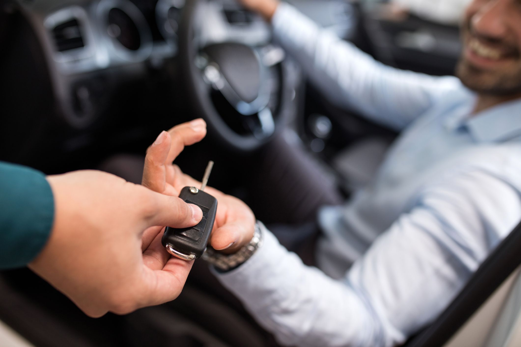 close up of a man receiving new car key royalty free image 1585152084
